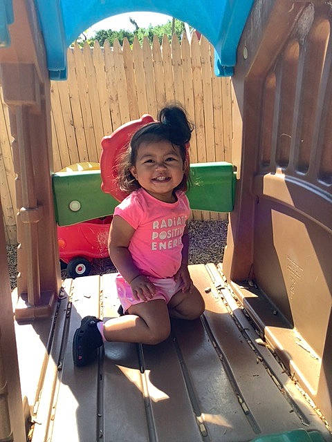 Jolie is registered to the contest to win money with this photo: child, chute, city, flip_flops, fun, happy, joy, leisure, magenta, outdoor_play_equipment, person, play, public_space, recreation, sandal, sitting, t_shirt, thigh, toddler, travel