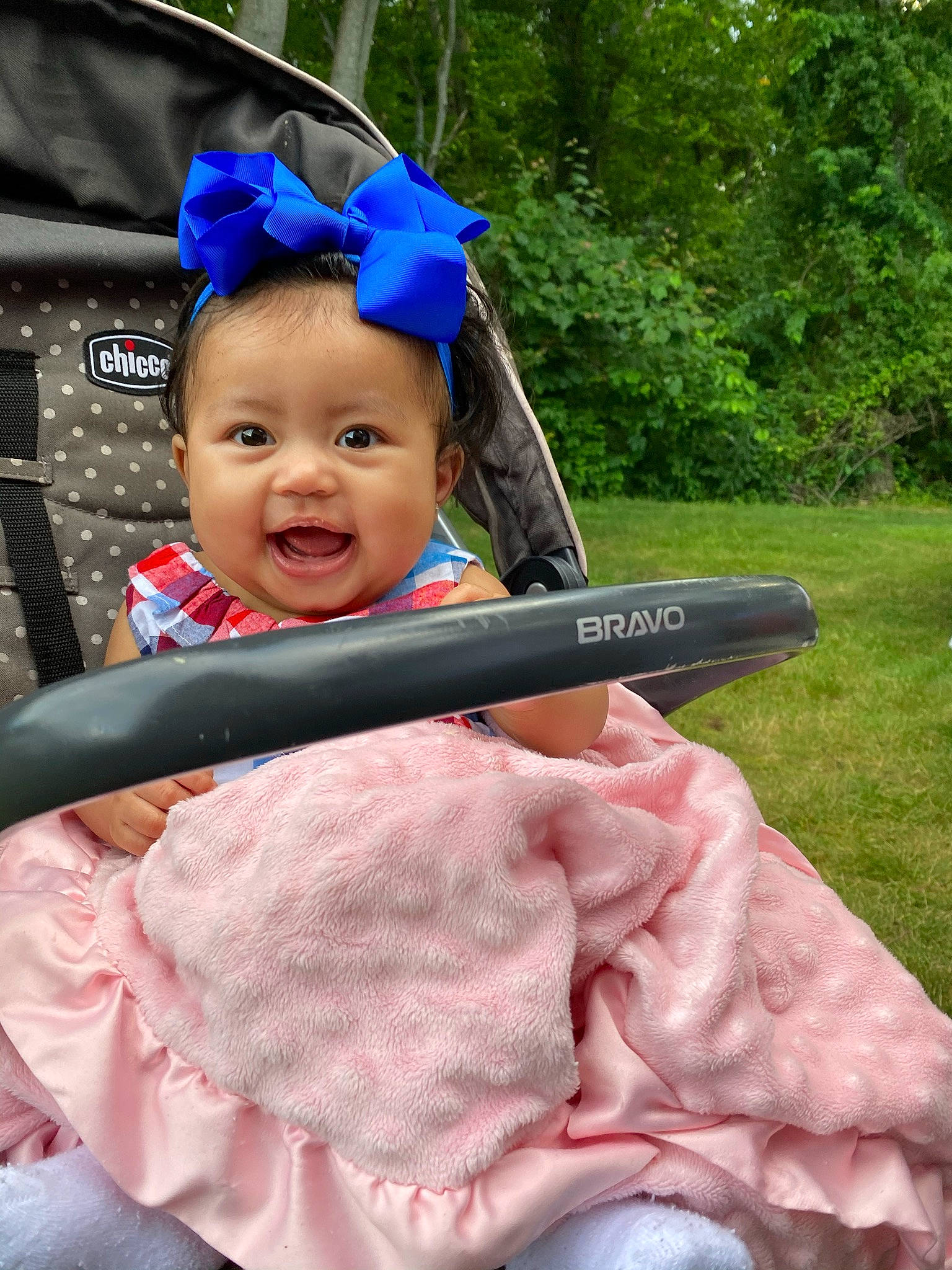 Jolie is registered to the contest to win money with this photo: blue, child, cool, electric_blue, eye, fashion_accessory, fun, grass, hairstyle, happy, head, headgear, leisure, person, personal_protective_equipment, pink, plant, recreation, smile, toddler