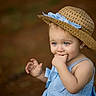 toddler, child, blue_eyes, straw_hat, blue_dress, cute, portrait, outdoor, baby, hand, fingers, earrings, summer_hat, expression, person, young_child, nature, soft_background, closeup, innocence