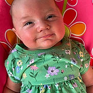 Daisy joined the competition — help win amazing prizes! baby, child, smiling, face, green_dress, floral_pattern, pink_background, flower_design, cute, infant, portrait, happy, skin, head, arm, sitting, indoors, closeup, person, childhood