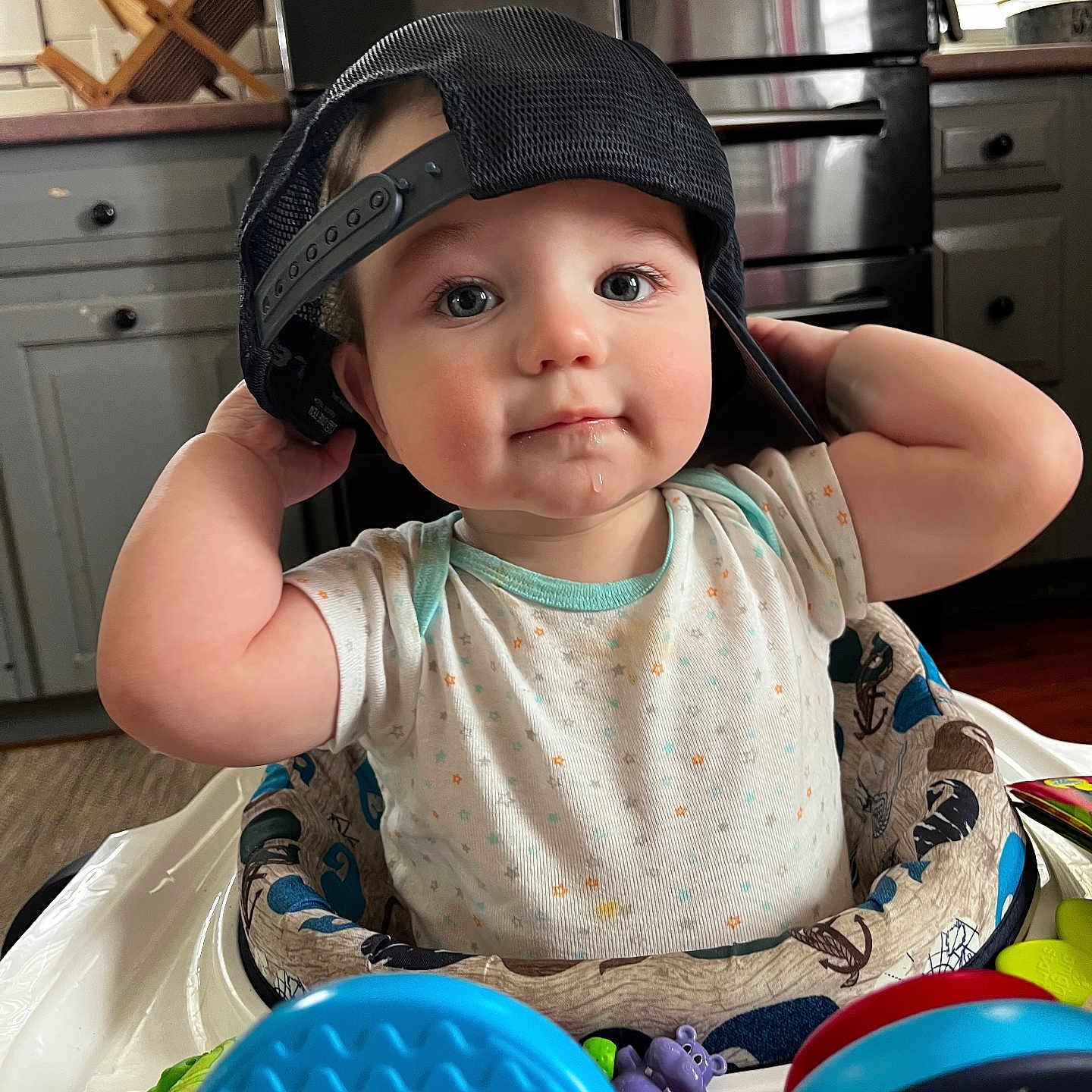 Levi is registered to the contest to win money with this photo: appliance, baby, baseballcap, bodypart, cap, clothing, device, electricaldevice, face, finger, hand, hardhat, hat, head, helmet, indoors, person, photography, portrait, wood