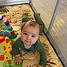baby, child, playpen, playmat, pajamas, crawling, drool, toy, colorful, infant, face, hands, floor, patterned, curious, indoors, soft, cute, young, person