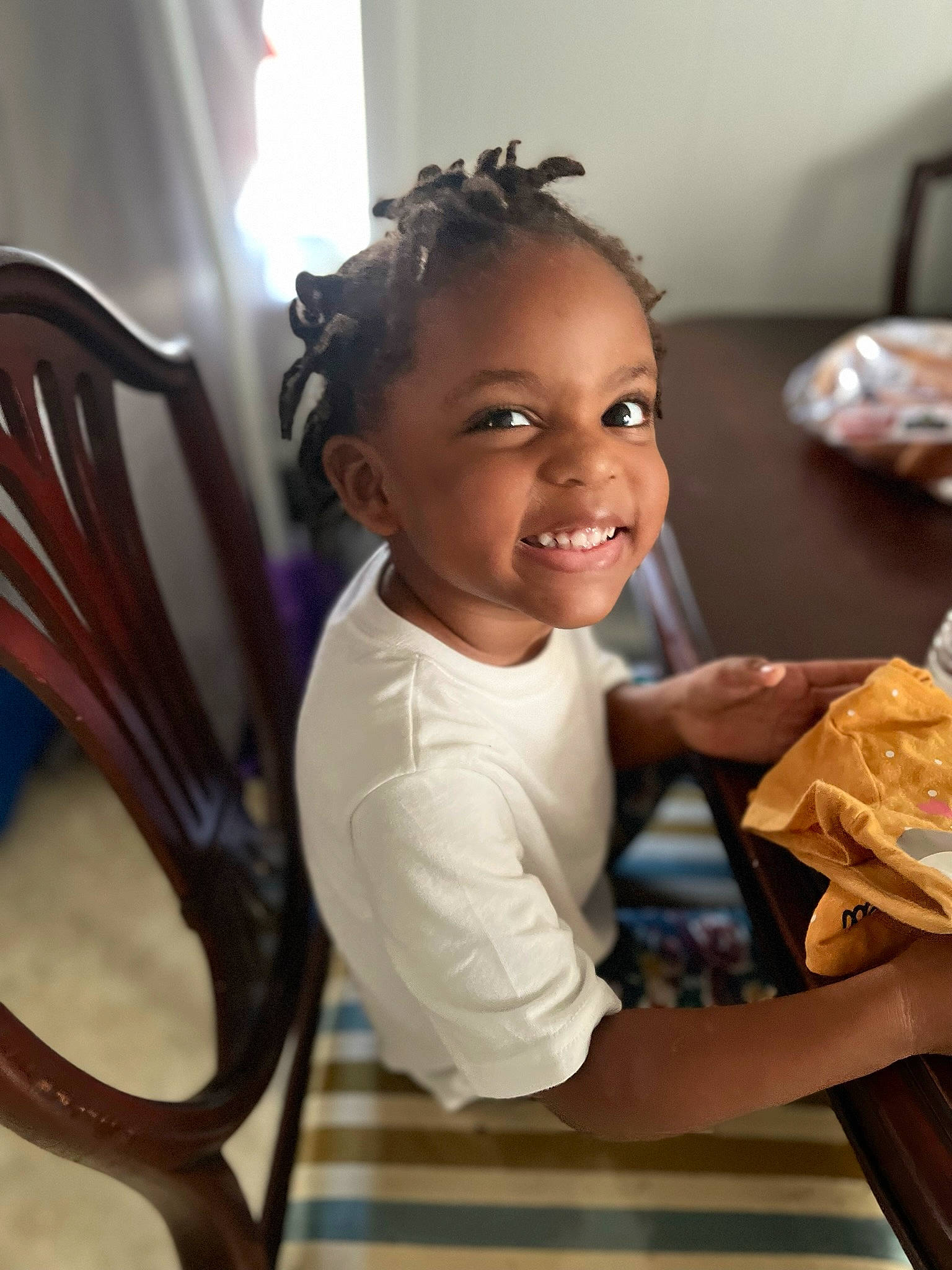 Ava is registered to the contest to win money with this photo: chair, child, fun, hairstyle, happy, joy, laugh, leisure, metal, paper_product, person, play, room, sitting, skin, smile, tableware, toddler, wood