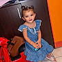 Antonia a rejoint le concours — aidez-le/la à gagner de superbes lots ! child, girl, toy_scooter, blue_dress, pink_slippers, indoor, floor_tiles, cabinet, brown_bag, toy_car, smiling, pigtails, hair_ties, playful, cute, person, footwear, furniture, colorful, happy