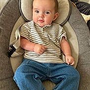 Henry is registered to the contest to win money with this photo: baby, baby_seat, casual, child, clothing, comfortable, cushion, cute, denim_pants, face, head, indoors, infant, person, portrait, relaxed, sitting, skin, striped_shirt, young_child
