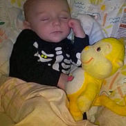 Avery is registered to the contest to win money with this photo: baby, sleeping, child, stuffed_toy, monkey, blanket, bed, cute, infant, pajamas, patterned_bedding, toddler, face, peaceful, indoor, soft_toy, resting, comfort, clothing, young_child