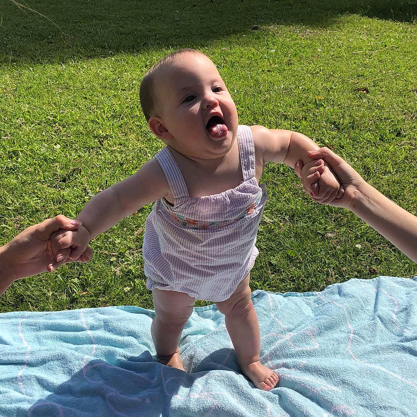 Verity is registered to the contest to win money with this photo: arm, baby, barefoot, child, facial_expression, fun, gesture, grass, happy, head, lawn, leaf, leisure, person, plant, play, smile, summer, toddler, vacation