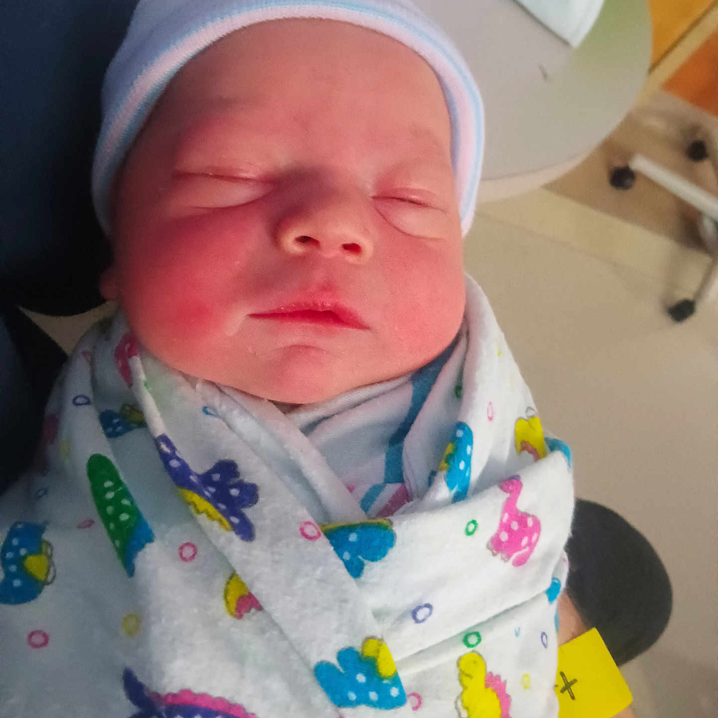 Michael is registered to the contest to win money with this photo: baby, blanket, cap, child, cute, holding, hospital, indoor, infant, medical, newborn, patterned_blanket, peaceful, person, portrait, resting, sleeping, swaddled, wrapped, young