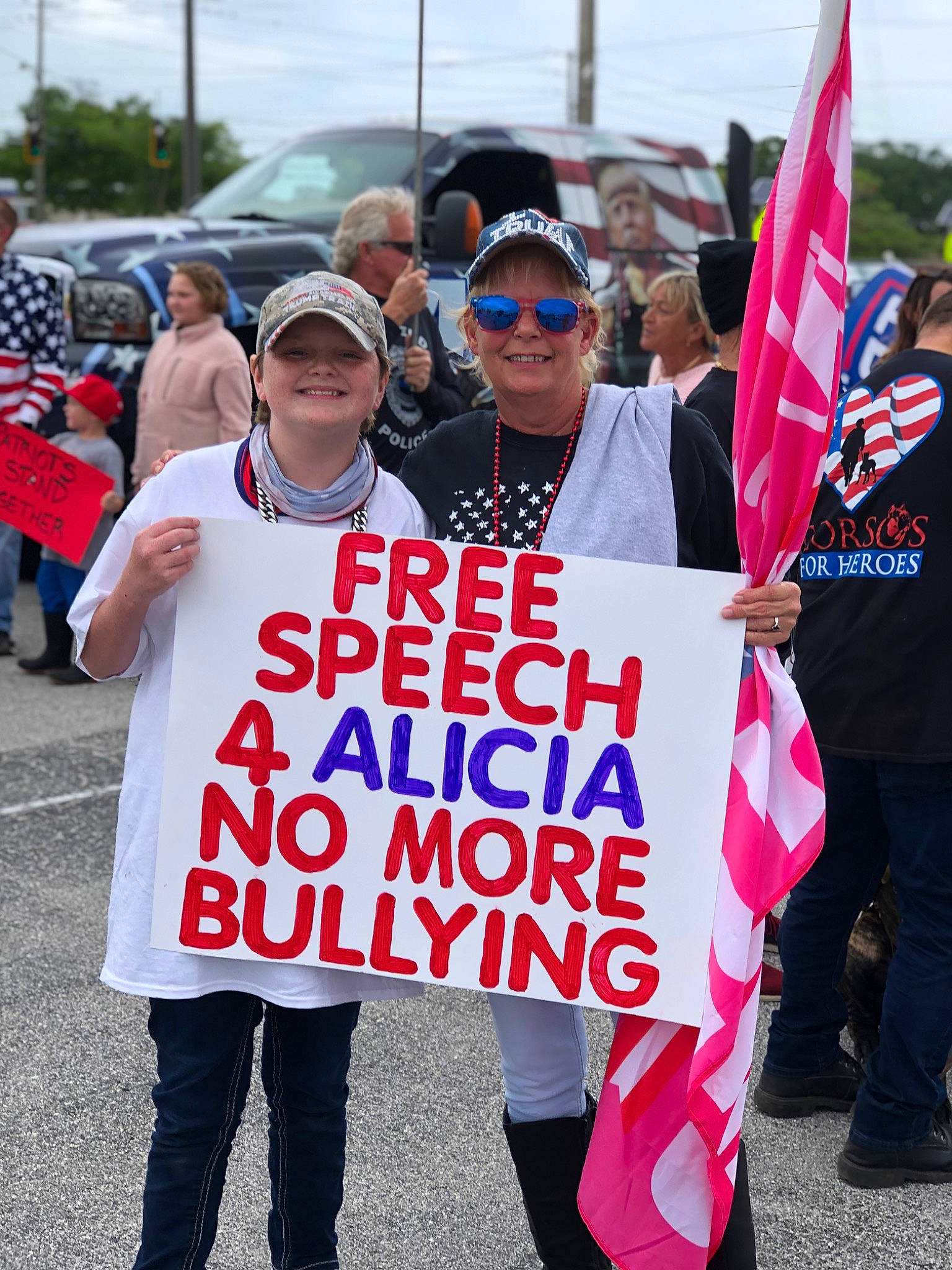 Alicia joined the competition — help win amazing prizes! baseball_cap, blurred, boot, clothing, community, crowd, event, eyewear, footwear, glasses, goggles, handwriting, hat, headwear, joy, motor_vehicle, person, poster, rebellion, shoe