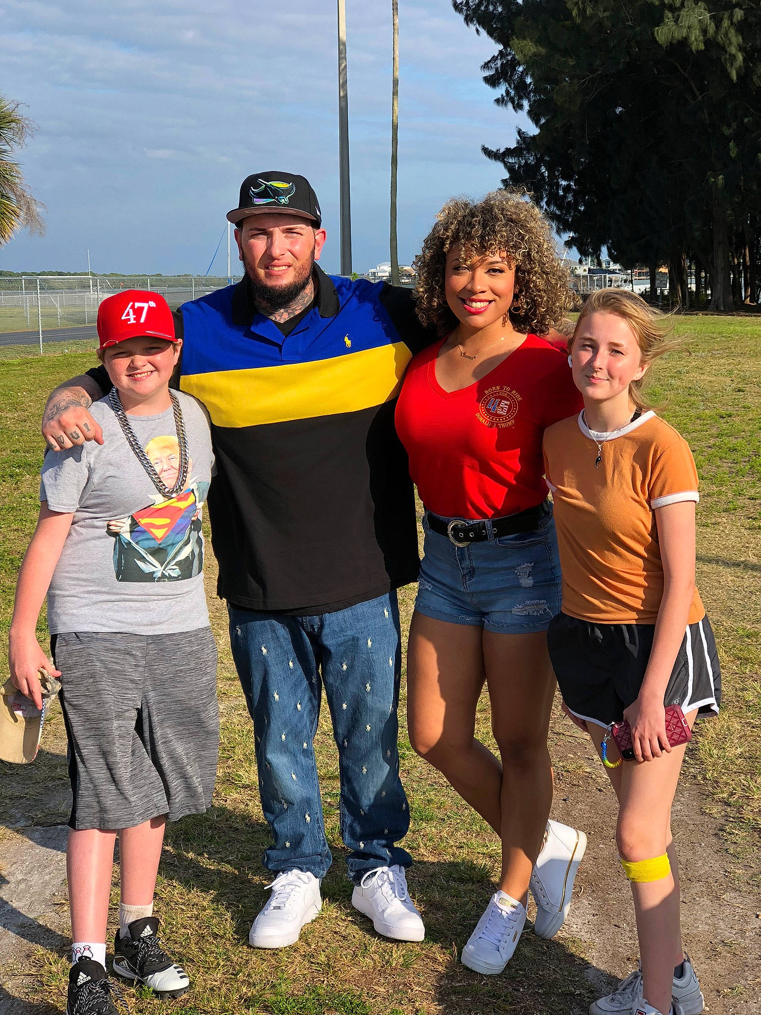 Alicia joined the competition — help win amazing prizes! clothing, eyewear, fun, gesture, grass, happy, hat, headwear, jeans, joy, leisure, people_in_nature, person, plant, recreation, shoe, shorts, sky, smile, sneakers