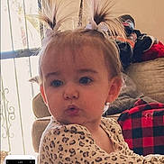 Maisey is registered to the contest to win money with this photo: toddler, child, indoor, pigtails, pout, window, sofa, blanket, plaid, home, furniture, cute, young_child, portrait, person, clothing, hair, face, expression, light