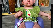 Maisey joined the competition — help win amazing prizes! baby, baby_clothing, candid, casual, child, curious_expression, cute, door, green_outfit, headband, headwear, home, infant, infant_toys, outdoor, person, pink_socks, purple_seat, seated, wooden_porch