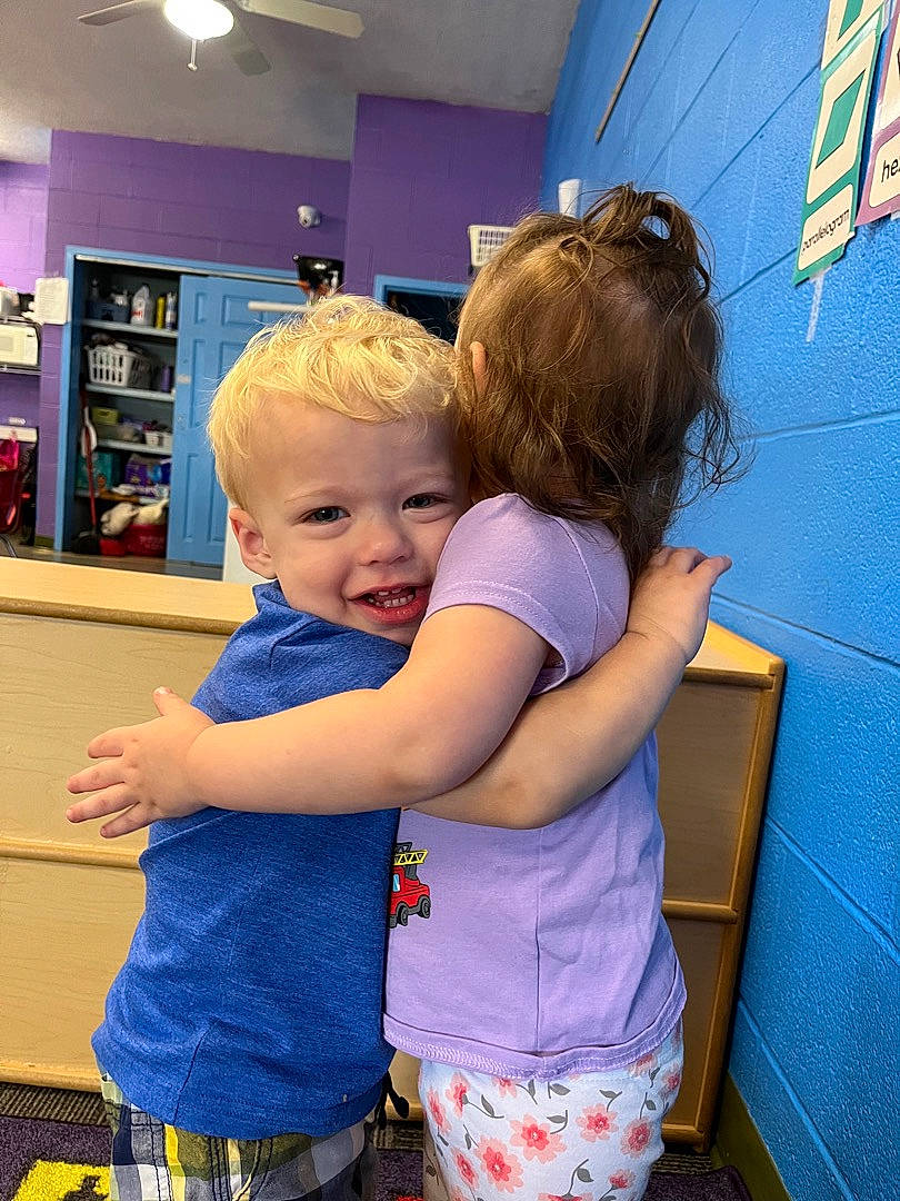 Braxley is registered to the contest to win money with this photo: baby, blue, child, electric_blue, event, flooring, fun, happy, leisure, light_fixture, person, play, recreation, room, shelf, standing, t_shirt, toddler, vacation