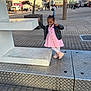 Zayna participe au concours pour gagner de l'argent avec cette photo : boots, buildings, child, daylight, fashion, fun, leather_jacket, letter_e, metal_platform, outdoor, pedestrians, pink_dress, playful, plaza, sculpture, sidewalk, street, tongue_out, tree, urban