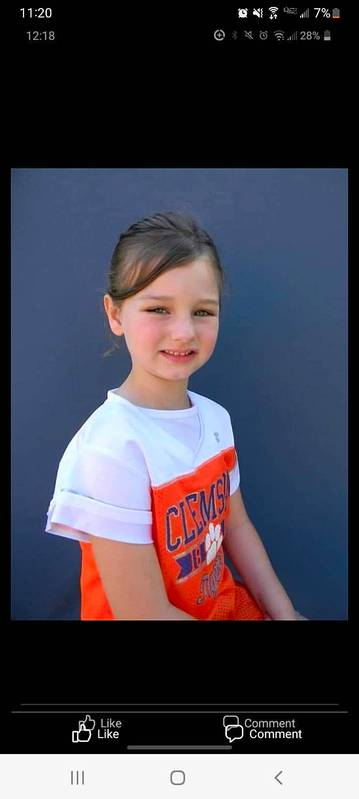 Riley is registered to the contest to win money with this photo: cheek, child, chin, display_device, elbow, electric_blue, flash_photography, font, fun, gesture, hairstyle, happy, jaw, joy, neck, person, rectangle, shoulder, sleeve, smile