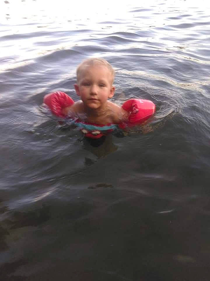 Dawson is registered to the contest to win money with this photo: child, eye, fun, happy, lake, leisure, lifejacket, liquid, ocean, open_water_swimming, person, personal_protective_equipment, play, recreation, sea, sports, toddler, water, wave, wind_wave