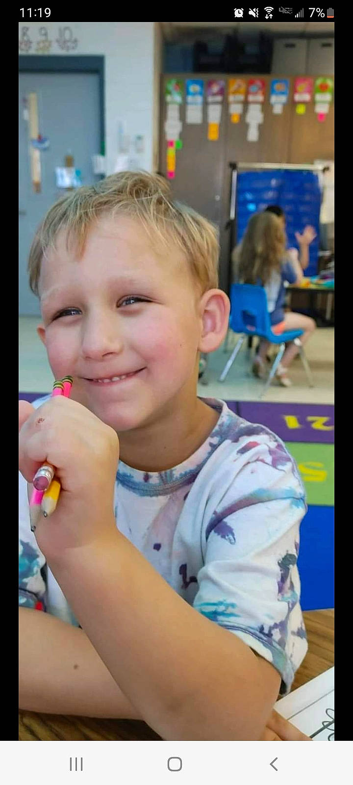 Dawson is registered to the contest to win money with this photo: adaptation, chair, child, event, eyelash, facial_expression, fun, gesture, happy, joy, leisure, person, play, recreation, room, sitting, smile, summer, t_shirt, thumb