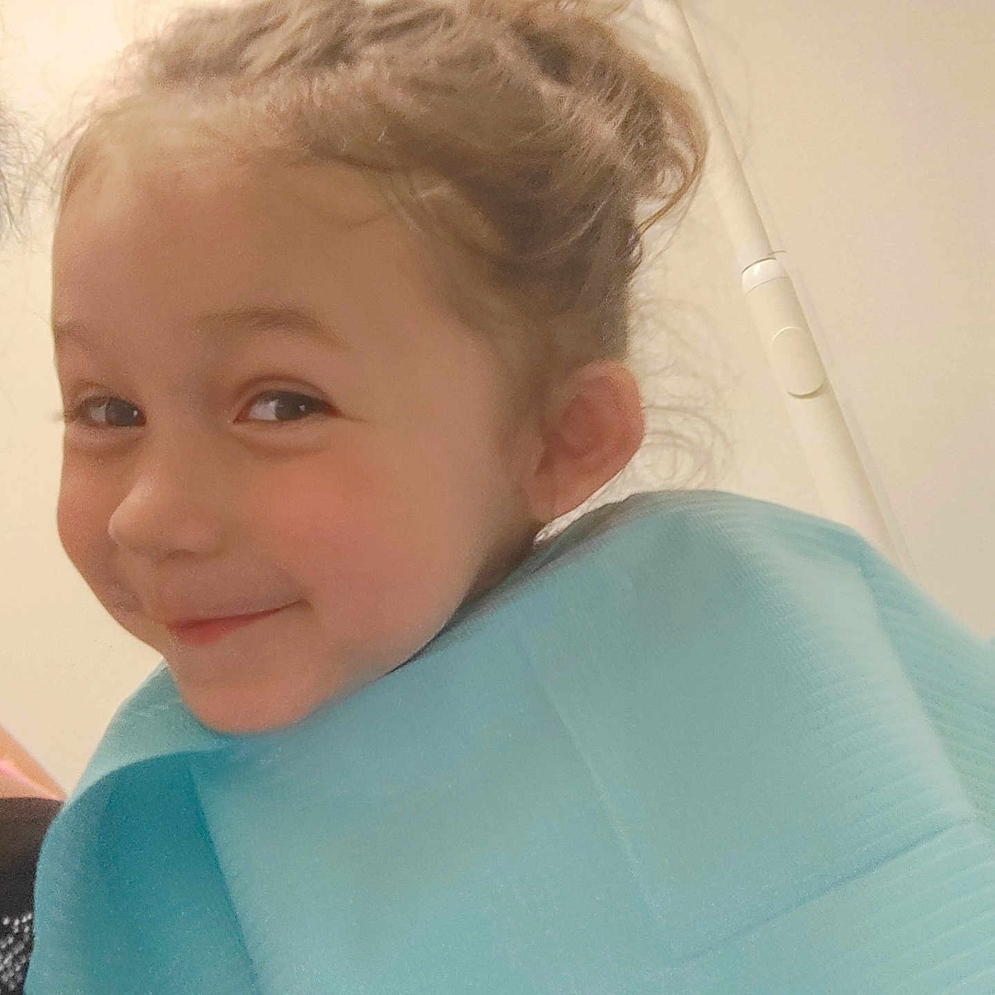 Jasmine joined the competition — help win amazing prizes! blue_bib, casual, child, childrens_clothing, closeup, curly_hair, cute, early_childhood, expression, face, hair_bun, happy, head, indoor, person, playful, portrait, skin, smile, young_child