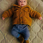 Dakota Zay joined the competition — help win amazing prizes! baby, infant, child, jacket, clothing, hat, pants, footwear, boots, mattress, pattern, lying_down, indoor, cute, face, portrait, warm_clothing, cozy, expression, small_hands