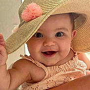 Lina participe au concours pour gagner de l'argent avec cette photo : baby, child, smile, hat, sunhat, flower, pink_flower, peach_dress, embroidery, cute, happy, portrait, closeup, face, waving, skin, cheerful, indoors, person, infant