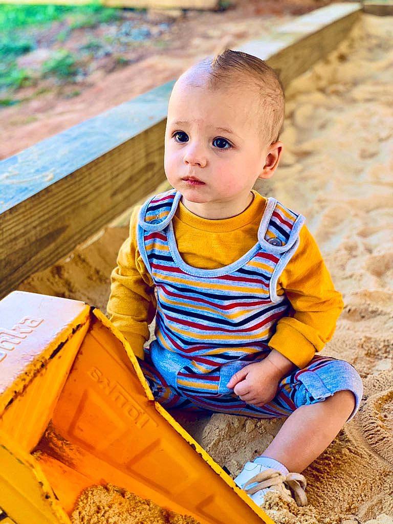 Elisha joined the competition — help win amazing prizes! baby, child, child_model, fun, leisure, person, play, sand, sandpit, sitting, smile, summer, toddler, vacation, wood, yellow