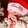 Loann participe au concours pour gagner de l'argent avec cette photo : baby, infant, christmas_hat, festive, holiday, cute, closeup, portrait, newborn, red_hat, white_hat, sleepwear, cozy, soft_skin, hand, face, eyes, indoors, celebration, child