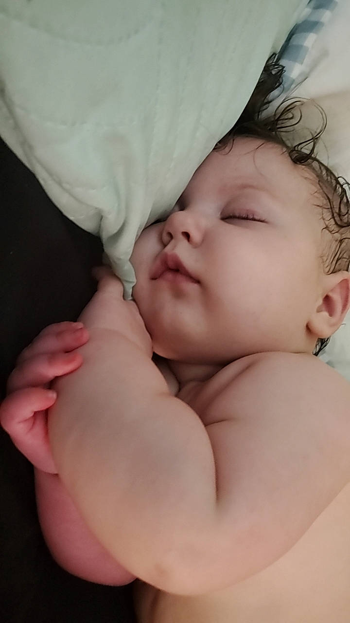 Iris is registered to the contest to win money with this photo: baby, baby_sleeping, cheek, child, comfort, ear, eye, eyebrow, eyelash, finger, gesture, hair, happy, human_body, linens, lip, nose, person, skin, thumb