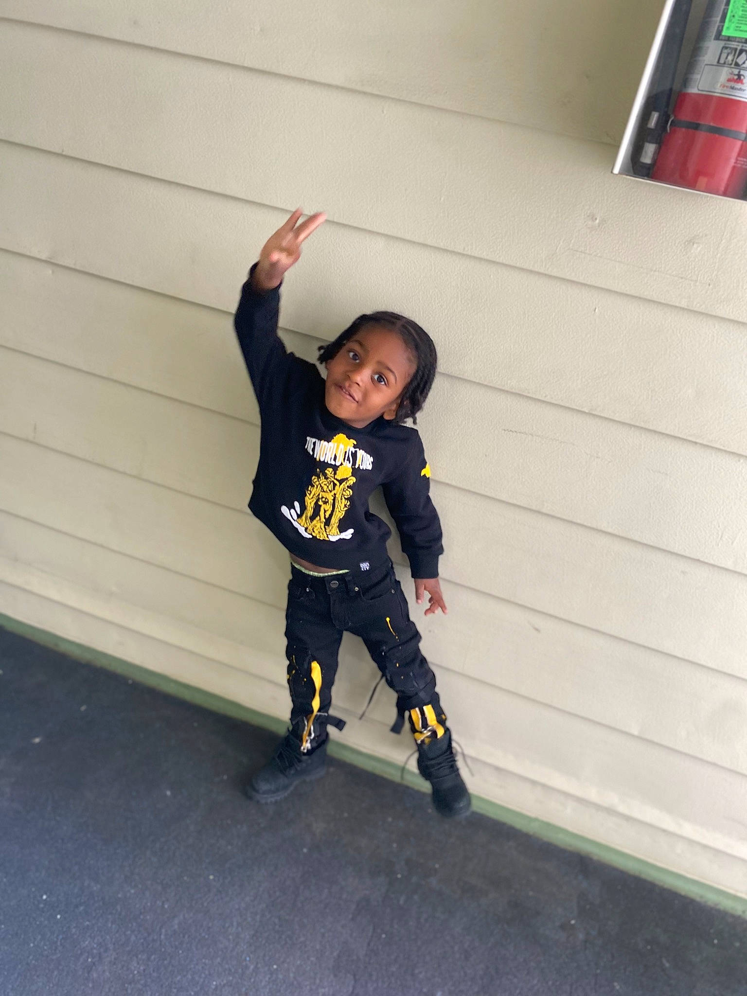 Auggi is registered to the contest to win money with this photo: asphalt, boot, child, door, electric_blue, flooring, fun, gesture, happy, knee, outdoor_shoe, person, recreation, rolling, room, sleeve, sweatpant, t_shirt, toddler, walking_shoe