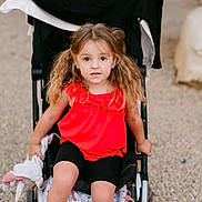 Ambre a rejoint le concours — aidez-le/la à gagner de superbes lots ! backpack, black_shorts, casual_clothing, child, curious, cute, daylight, expression, girl, gravel, outdoor, person, pigtails, portrait, red_top, sitting, soft_toy, stroller, summer, young_child