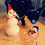black_cat, snowman, decoration, table, indoor, curious, glasses, red_hat, holiday, winter, snowflake_effect, toy, pet, feline, houseplant, floor, curtain, window, cozy, decor