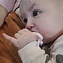 Willow is registered to the contest to win money with this photo: baby, pacifier, hand, face, infant, closeup, sleepwear, blanket, person, skin, eyebrow, eyelash, clothing, arm, indoor, young_child, cute, soft_light, resting, portrait