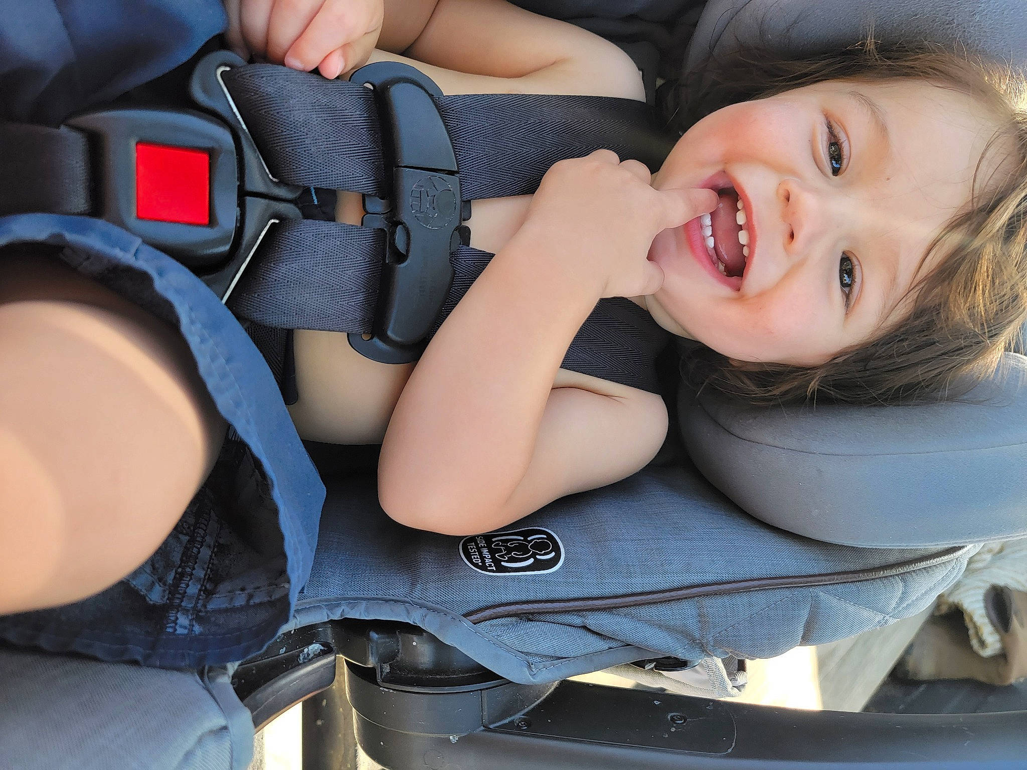 Gunner is registered to the contest to win money with this photo: auto_part, automotive_design, baby, baby_carriage, baby_in_car_seat, baby_laughing, baby_toddler_clothing, beauty, car_seat, comfort, finger, gesture, happy, human_body, joy, mouth, person, product, smile, toddler