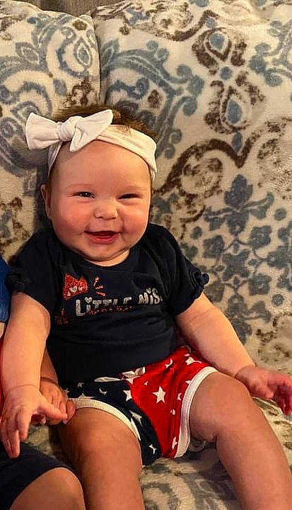 Scarlett is registered to the contest to win money with this photo: baby, baby_toddler_clothing, cap, cheek, chin, clothing, eye, flash_photography, happy, headwear, joy, knee, leg, lip, mouth, person, shorts, skin, sleeve, smile
