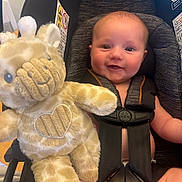 Bronson joined the competition — help win amazing prizes! baby, car_seat, plush_toy, giraffe, smiling, child, infant, seatbelt, cute, indoor, safety, toy, happiness, childcare, portrait, person, soft_toy, seat, baby_clothing, happy