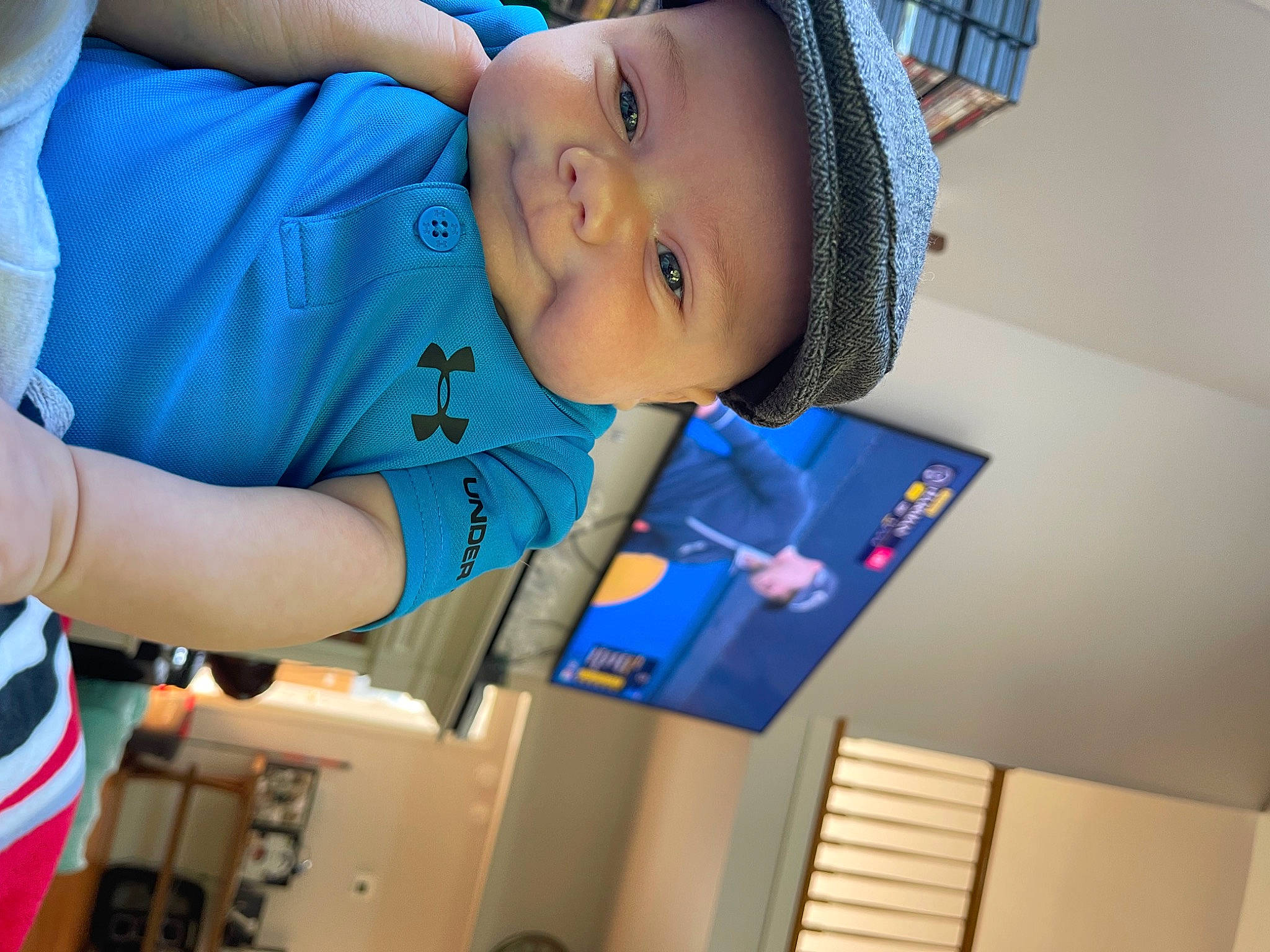 Jack is registered to the contest to win money with this photo: arm, azure, baby, baseball_cap, blue, cap, child, elbow, electric_blue, fashion_accessory, fun, happy, hat, headwear, leisure, person, personal_protective_equipment, room, smile, t_shirt