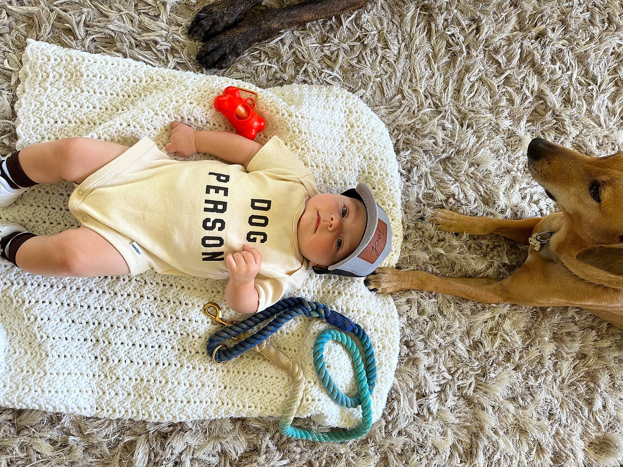 Jack is registered to the contest to win money with this photo: abdomen, baby, baby_toddler_clothing, child, comfort, foot, fun, headwear, human_body, human_leg, leg, leisure, linens, mammal, people_in_nature, person, sitting, sunglasses, thigh, toddler