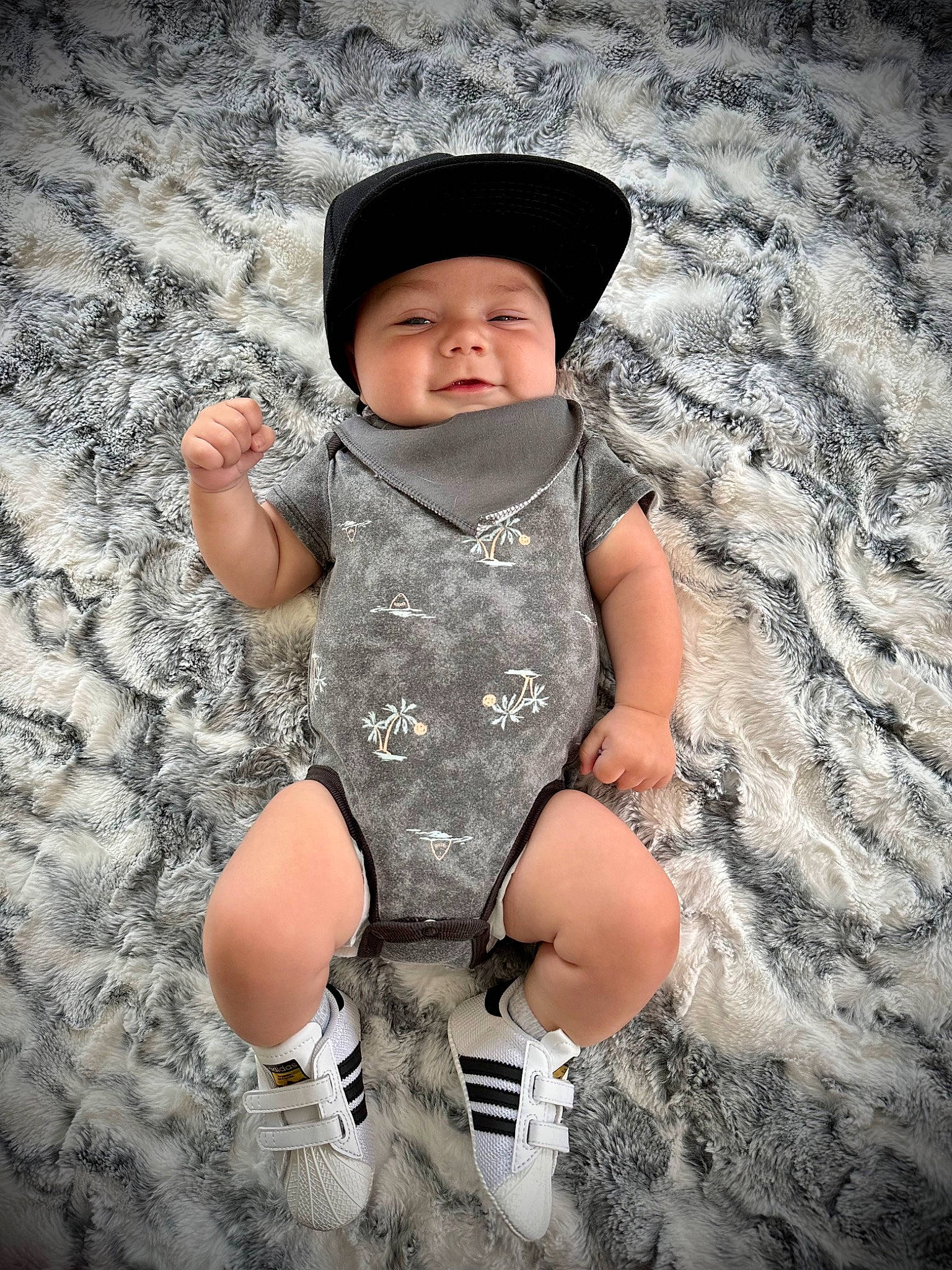 Jack is registered to the contest to win money with this photo: baby, baby_toddler_clothing, child, cool, costume_hat, fashion_accessory, finger, flash_photography, fun, grass, happy, hat, headwear, monochrome, pattern, people_in_nature, person, personal_protective_equipment, sitting, sleeve