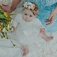 Ruth joined the competition — help win amazing prizes! baby, flower_crown, blue_eyes, white_dress, tulips, yellow_flowers, lace_blanket, hands, sitting, cute, infant, child, portrait, soft_light, nature, spring, floral, innocence, tenderness, family