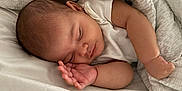 Samira is registered to the contest to win money with this photo: arm, baby, bed, blanket, closeup, comfort, cozy, cute, face, hand, infant, newborn, peaceful, rest, serene, skin, sleeping, soft, toddler, white