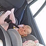 baby, car_seat, child, infant, pink_clothing, stuffed_animal, car_interior, seatbelt, window, headrest, smiling, safety, transportation, toddler, cute, comfort, child_safety, seat, happy, young_child