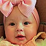 baby, infant, face, headband, bow, pink, peach, clothing, cute, portrait, child, young, closeup, smile, expressive_eyes, adorable, soft, texture, fabric, background