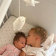 Inaya a rejoint le concours — aidez-le/la à gagner de superbes lots ! baby, child, crib, sibling, cuddle, kiss, plush_toys, star, cloud, infant, toddler, sleepwear, cute, family, love, bedroom, soft_lighting, home, portrait, together