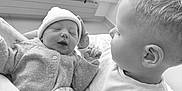 Adonis a rejoint le concours — aidez-le/la à gagner de superbes lots ! baby, child, newborn, infant, blanket, bed, indoor, window, curtains, clothing, person, family, love, tenderness, holding, sleeping, hat, sweater, curly_hair, black_and_white