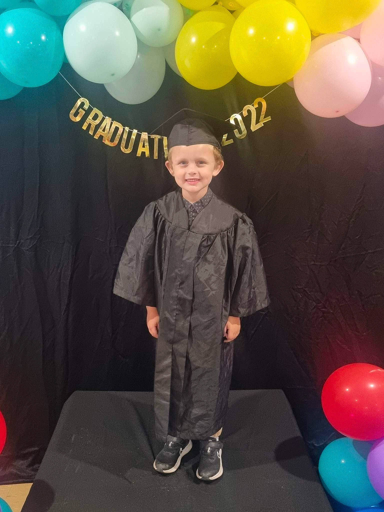 Archer is registered to the contest to win money with this photo: balloon, clothing, electric_blue, event, fashion_design, flooring, formal_wear, fun, happy, hat, headwear, joy, light, magenta, party_supply, person, photograph, sleeve, smile, snapshot