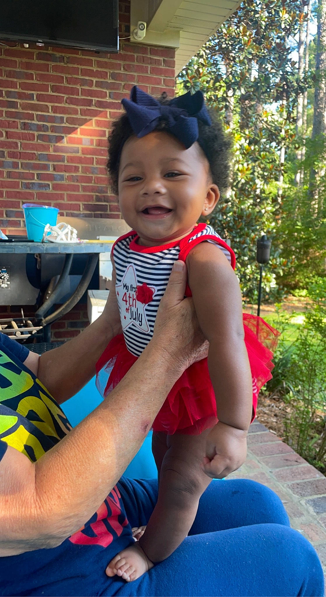 Braylee is registered to the contest to win money with this photo: baby_toddler_clothing, blue, child, computer_keyboard, cool, electric_blue, fun, happy, human_leg, joy, leisure, person, personal_protective_equipment, plant, recreation, sitting, smile, t_shirt, thigh, toddler