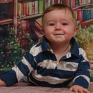 Owen a rejoint le concours — aidez-le/la à gagner de superbes lots ! baby, child, smile, striped_shirt, face, eyes, hand, floor, indoor, portrait, person, happy, crawling, young_child, clothing, background, bookshelf, colorful, cute, toddler