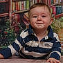 Owen participe au concours pour gagner de l'argent avec cette photo : baby, child, smile, striped_shirt, face, eyes, hand, floor, indoor, portrait, person, happy, crawling, young_child, clothing, background, bookshelf, colorful, cute, toddler