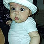 baby, child, face, hat, white_clothing, indoor, person, hand, curious, wide_eyes, infant, cute, closeup, chubby_cheeks, portrait, holding, adult_hand, white_hat, bow, skin