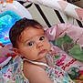 Sarah participe au concours pour gagner de l'argent avec cette photo : baby, infant, playpen, toy, colorful, face, curious, child, indoors, floor, cushion, pacifier, clothing, pattern, head, eyes, person, toddler, cute, expression