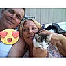 couple, man, woman, cat, selfie, smiling, outdoor, fence, holding, emoji, heart_eyes, face, pet, casual, portrait, timestamp, phone_interface, happy, people, animal